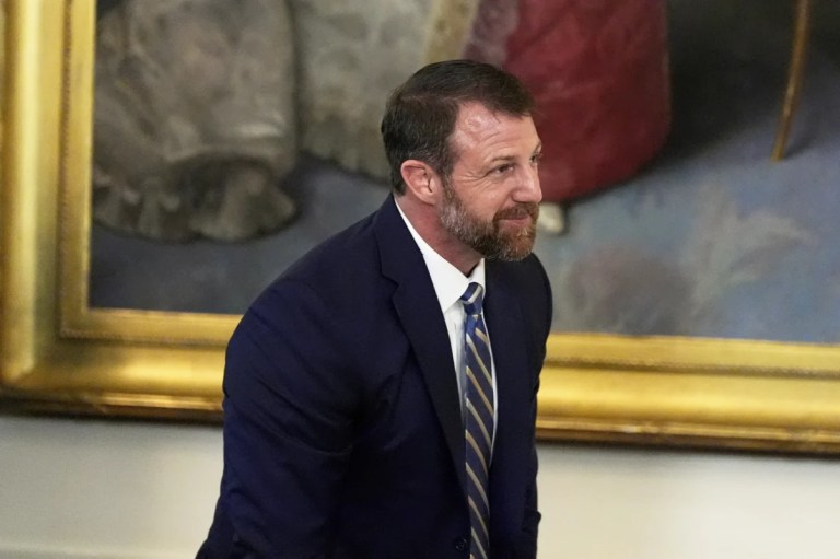 Sen. Markwayne Mullin, R-Okla., stands as President Donald Trump speaks during a signing event for a bill blocking California's rule banning the sale of new gas-powered cars by 2035, in the East Room of the White House, Thursday, June 12, 2025, in Washington. (AP Photo/Alex Brandon)