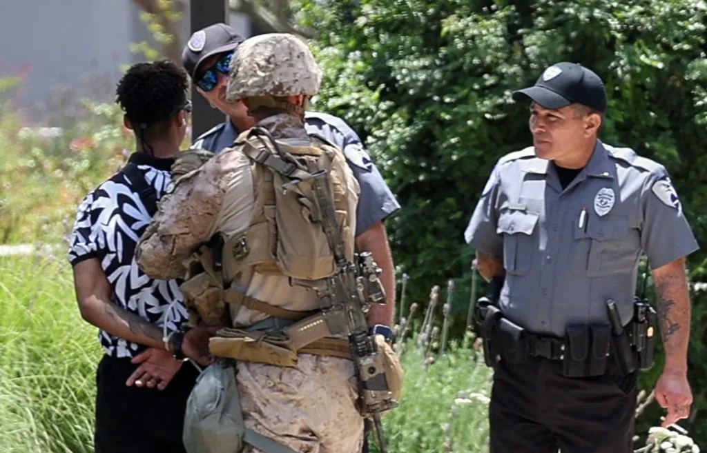 U.S. Marines detain a person outside the Wilshire Federal Building after Marines were deployed to Los Angeles, as protests against federal immigration sweeps continue, in Los Angeles, California, U.S. June 13, 2025.