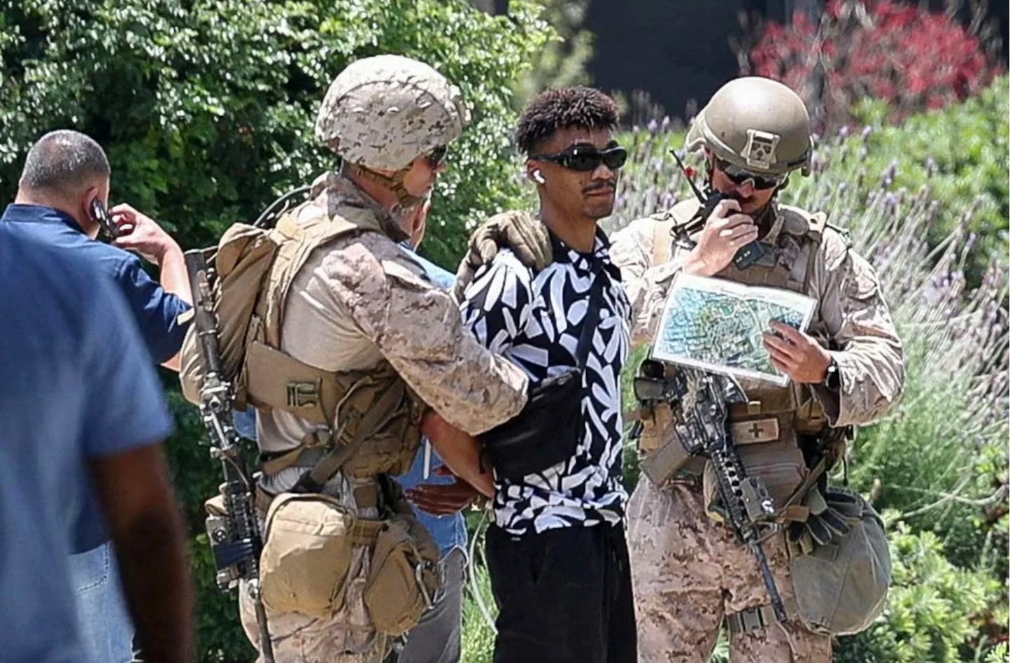 U.S. Marines detain a person outside the Wilshire Federal Building after Marines were deployed to Los Angeles, as protests against federal immigration sweeps continue, in Los Angeles, California, U.S. June 13, 2025. 