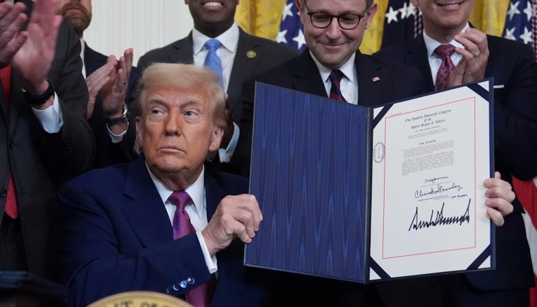 President Donald Trump holds up a signed bill blocking California's rule banning the sale of new gas-powered cars by 2035 in the East Room of the White House, Thursday, June 12, 2025, in Washington. (AP Photo/Evan Vucci)