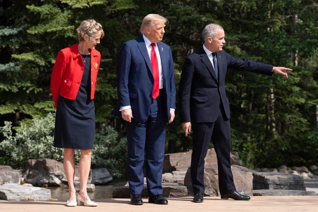 US President Donald Trump is greeted by Diana Fox Carney and the Prime Minister of Canada Mark Carney, right, at the G7 summit in Kananaskis, Alberta, Canada, Monday June 16, 2025. (Stefan Rousseau/Pool Photo via AP)