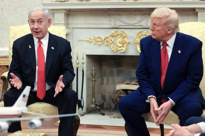 President Donald Trump, right, listens as Israeli Prime Minister Benjamin Netanyahu speaks during a meeting in the Oval Office at the White House in Washington, April 7, 2025.