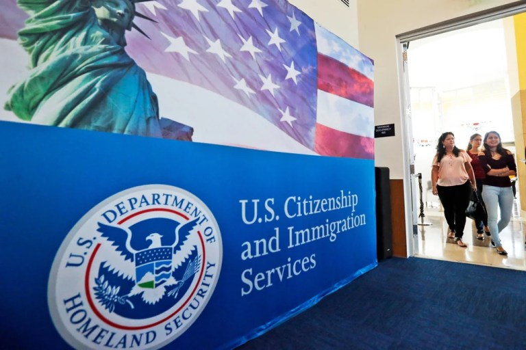 People arrive at the U.S. Citizenship and Immigration Services in Miami, Florida, Aug. 17, 2018.