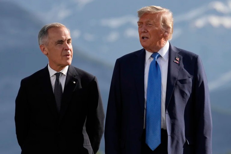 Canada's Prime Minister Mark Carney, listens as President Donald Trump speaks during a group photo at the G7 Summit, Monday, June 16, 2025, in Kananaskis, Canada.