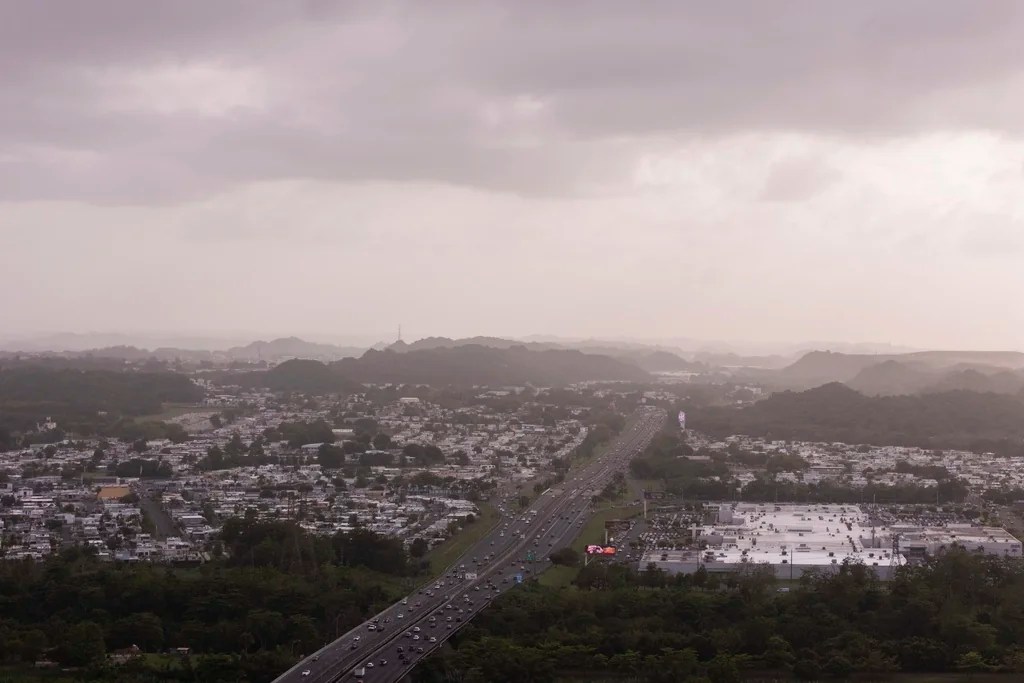 Cars drive along a highway as a cloud of dust from the Sahara Desert blankets most of the Caribbean, in Cataño, Puerto Rico, Monday, June 2, 2025.