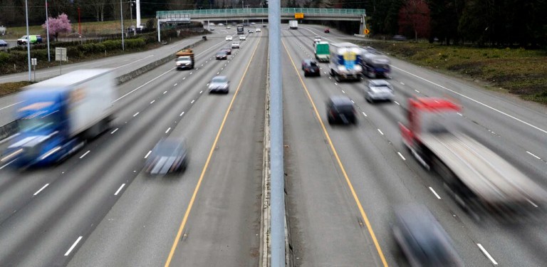 FILE - In this Monday, March 25, 2019, file photo, cars and trucks travel on Interstate 5 near Olympia, Wash. A new study says that safety features such as automatic emergency braking and forward collision warnings could prevent more than 40% of crashes in which semis rear-end other vehicles. (AP Photo/Ted S. Warren, File)