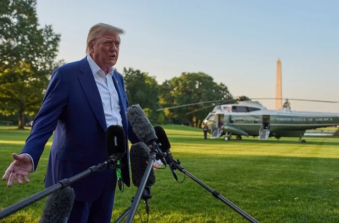 President Donald Trump speaks with reporters before boarding Marine One on the South Lawn of the White House