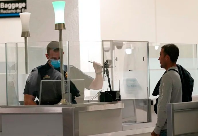 International passengers arrive at Miami international Airport where they are screened by U.S. Customs and Border Protection (CBP) using facial biometrics to automate manual document checks required for admission into the U.S. Friday, Nov. 20, 2020, in Miami. Miami International Airport is the latest airport to provide Simplified Arrival airport-wide. (AP Photo/Lynne Sladky)