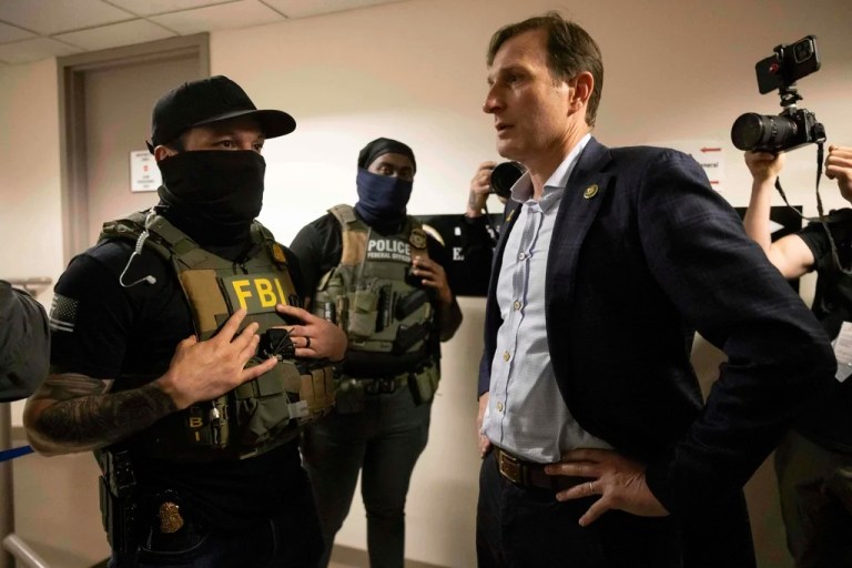 Rep. Dan Goldman (D-NY), left, speaks to the federal agents at the Jacob K. Javits federal building, Wednesday, June 18, 2025, in New York.