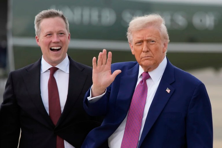 President Donald Trump waves as Secretary of the U.S. Army Daniel Driscoll watches at Pope Army Airfield at Fort Bragg, Tuesday, June 10, 2025, in Fort Bragg, N.C.