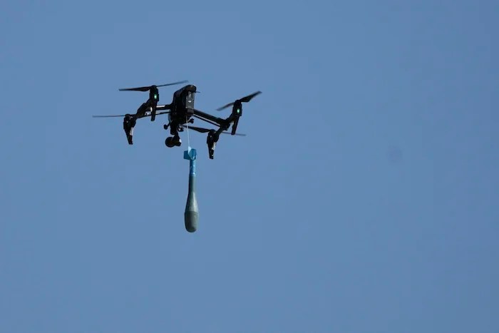 A drone carries a mortar shell as soldiers take part in the U.S.-led Immediate Response 25 military exercise in Petrochori, northern Greece Wednesday, June 4, 2025. (AP Photo/Thanassis Stavrakis)