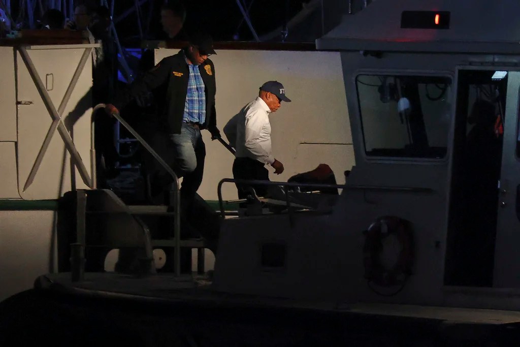 New York Mayor Eric Adams, right, disembarks a masted Mexican Navy training ship after boarding it with a New York Police Harbor Unit after it collided with the Brooklyn Bridge, Saturday, May 17, 2025, in New York.