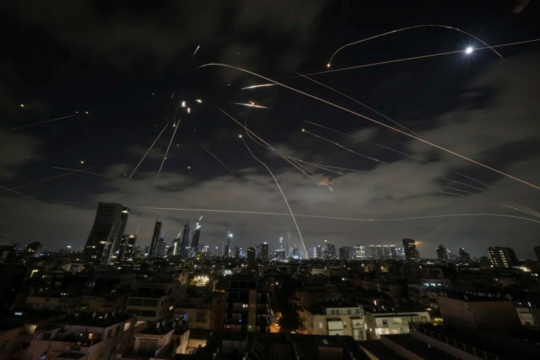 The Israeli Iron Dome air defense system fires to intercept missiles during an Iranian attack over Tel Aviv, Israel, Sunday, June 15, 2025.