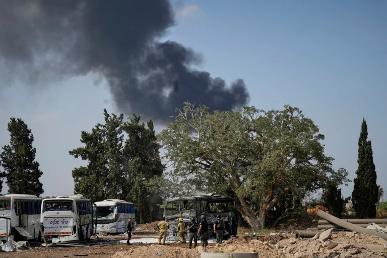 Israeli security forces inspect a site hit by a missile launched from Iran in central Israel on Tuesday, June 17, 2025. (AP Photo/Baz Ratner)