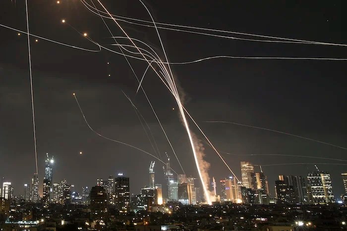 ALTERNATIVE CROP OF XEM124. A projectile hit buildings as Israeli Iron Dome air defense system fires to intercept missiles over Tel Aviv, Israel, Friday, June 13, 2025.