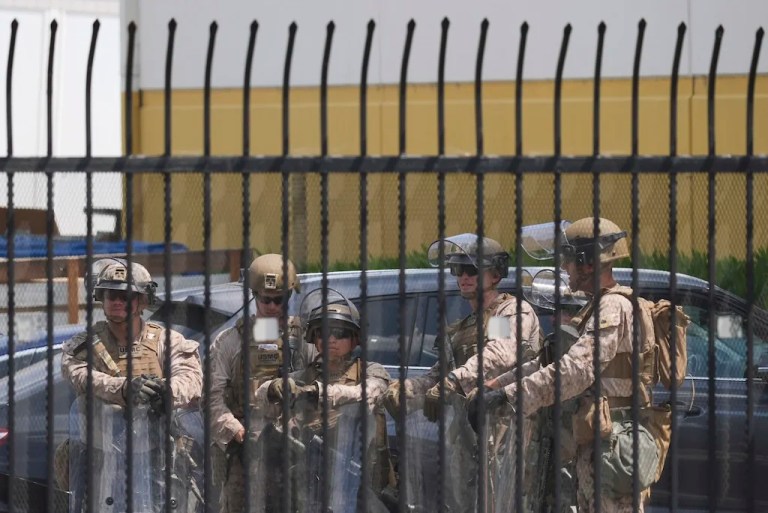 U.S. Marines stage outside a business park on Monday, June 23, 2025, in Paramount, Calif. (AP Photo/Damian Dovarganes)