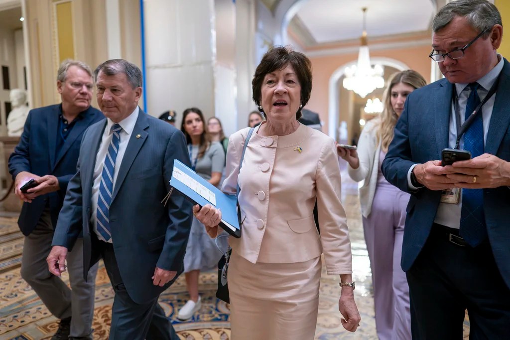 Sen. Susan Collins, R-Maine, center, joined at left by Sen. Mike Rounds, R-S.D., arrives at the Senate chamber at the Capitol in Washington, Thursday, June 1, 2023.