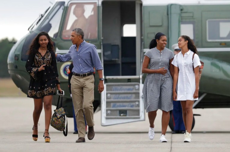 President Barack Obama with first lady Michelle Obama and their daughters Malia, right, and Sasha Obama, left, walk on the tarmac to board Air Force One at Air Station Cape Cod in Mass., Sunday, Aug. 21, 2016. Obama is returning from vacation rested and ready for a busy fall, including pressing Congress for money to protect against the Zika virus and fending off lawmakers' attacks over the administration's $400 million 