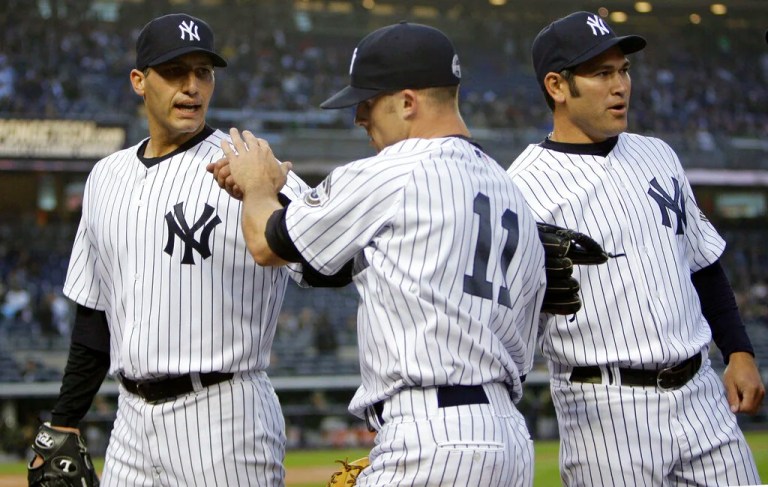 New York Yankees pitcher Andy Pettitte, left, and Johnny Damon, right, greet Brett Gardner at the dugout after Gardner made a leaping catch on a ball hit deep by Oakland Athletics' Jason Giambi in the first inning of a baseball game Tuesday, April 21, 2009, at Yankee Stadium in New York. (AP Photo/Julie Jacobson)