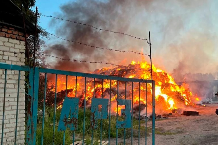 In this photo released by Acting Governor of the Kursk Region Alexander Khinshtein telegram channel on Saturday, May 31, 2025, a view of a fire at the territory of an agrofirm after Ukrainian drones struck near Rylsk in the western Kursk region of Russia.