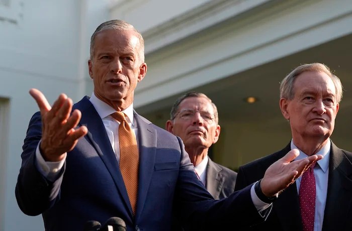 Senate Majority Leader John Thune, R-S.D., flanked by Sen. John Barrasso, R-Wyo., center, and Sen. Mike Crapo, R-Idaho, speak with reporters after meeting with President Donald Trump