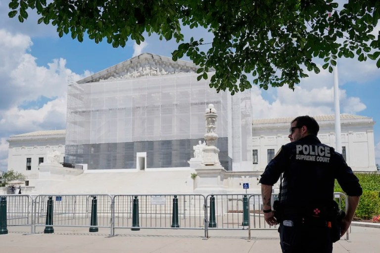 A U.S. Supreme Court police officer stands watch outside of the Supreme Court, June 26, 2025, in Washington. (AP Photo/Mariam Zuhaib)