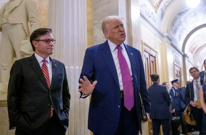 President Donald Trump, right, is joined by Speaker of the House Mike Johnson (R-LA) as he arrives for a meeting with the House Republican Conference at the Capitol, Tuesday, May 20, 2025, in Washington.