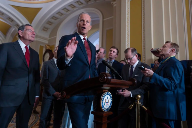 Senate Majority Leader John Thune (R-SD), center, joined at left by Sen. John Barrasso (R-WY), the GOP whip, speaks to reporters after Republican senators met with Treasury Secretary Scott Bessent and worked on President Donald Trump's tax and immigration megabill so it can be on his desk by July 4, at the Capitol in Washington, Tuesday, June 24, 2025.