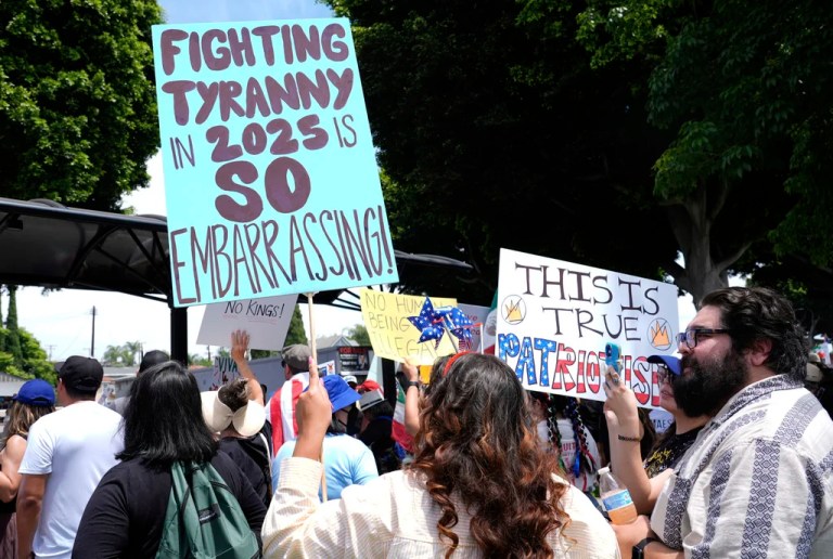 Protesters holds signs during a 