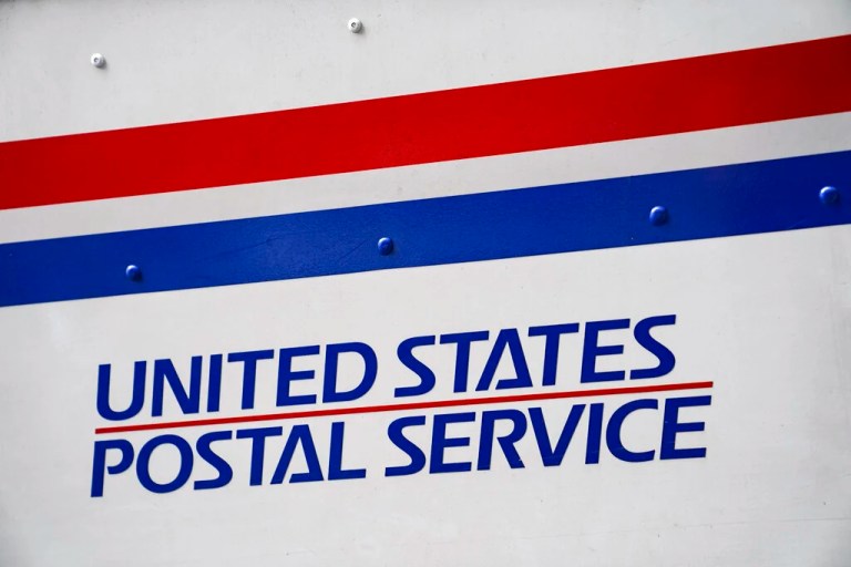 A U.S. Postal Service delivery truck is parked beside the Canal Street station, Monday, Aug. 17, 2020, in New York. (AP Photo/John Minchillo)