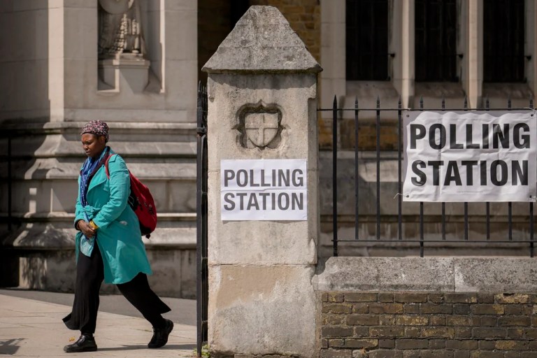 A woman exits a polling station set up at St George's Cathedral in London, Thursday, July 4, 2024. Voters in the U.K. are casting their ballots in a national election to choose the 650 lawmakers who will sit in Parliament for the next five years.