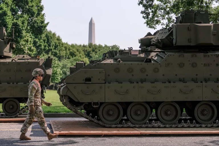 A U.S. Army soldier walks past a Bradley fighting vehicle staged in West Potomac Park ahead of an upcoming military parade commemorating the Army's 250th anniversary and coinciding with Donald Trump's 79th birthday, Wednesday, June 11, 2025, in Washington.