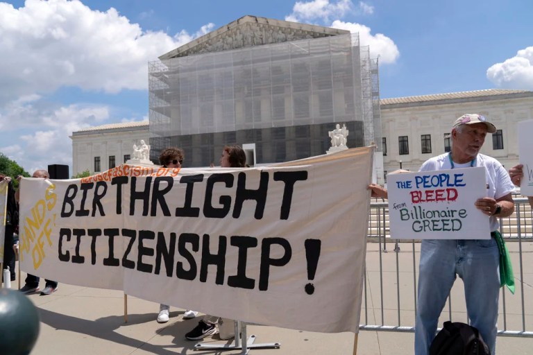 Demonstrators hold up a banner during a citizenship rally outside of the Supreme Court in Washington, May 15, 2025.
