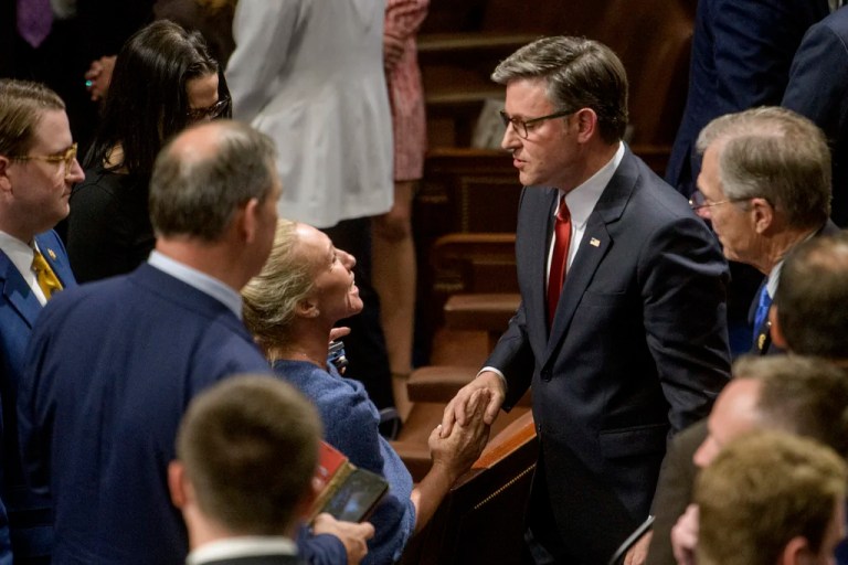 Rep. Marjorie Taylor-Greene (R-GA), center left, shakes hands with Speaker of the House Mike Johnson (R-LA) in the House chamber during final passage of President Donald Trump's signature bill of tax breaks and spending cuts, at the Capitol, Thursday, July 3, 2025, in Washington.