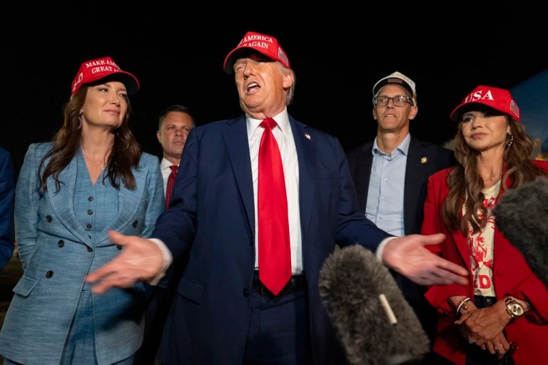 President Donald Trump, center, speaks with reporters as, from left, Agriculture Secretary Brooke Rollins, Reps. Zachary Nunn (R-IA) and Randy Feenstra (R-IA), and Homeland Security Secretary Kristi Noem listen as they arrive on Air Force One, Friday, July 4, 2025, at Joint Base Andrews, Maryland.