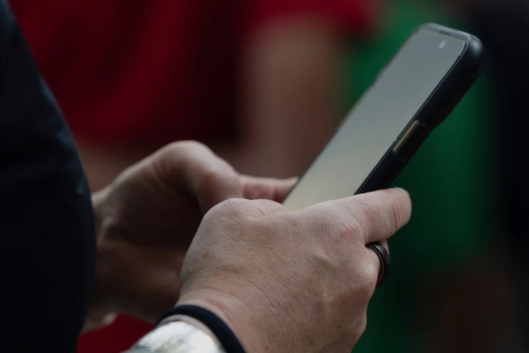 A person looks at their phone at Seattle-Tacoma International Airport on Sunday, June 1, 2025.
