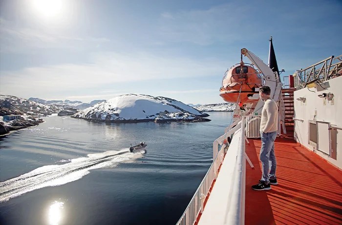 Reporter Daniel Allott sailing north on the Arctic Umiaq line, May 2025. (Bethany Williams)