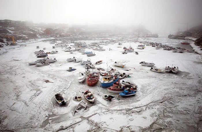 Boats frozen in the harbor in Ilulissat, Greenland, May 2025. (Bethany Williams)