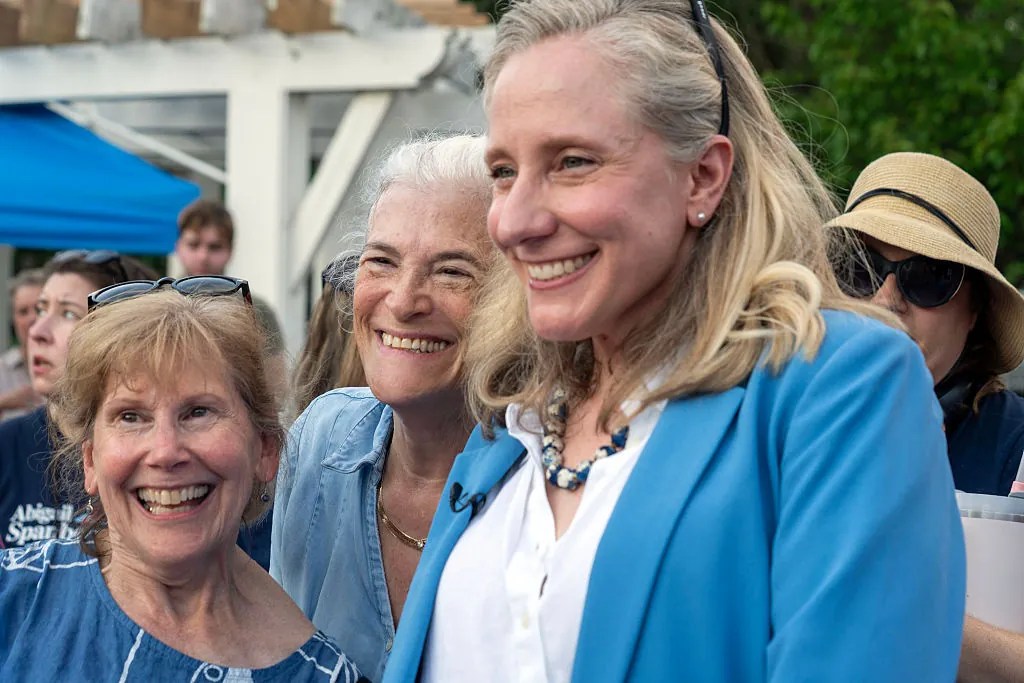 Elaine Runkle (left), 62, and Ilyse Gart (center), 69, pose with gubernatorial candidate Abigail Spanberger's during her tour bus at the Stacy C. Sherwood Community Center in Fairfax, Virginia on Jun 26,2025. (Photo by Maxine Wallace/The Washington Post via Getty Images)