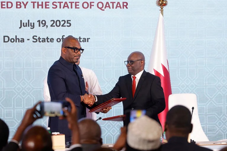 Peace mediator Sumbu Sita Mambu, a high representative of the head of state in the Democratic Republic of Congo (L), and Rwanda-backed armed group M23 executive secretary Benjamin Mbonimpa (R) shake hands after signing a ceasefire deal in the Qatari capital Doha on July 19, 2025 to end fighting that has devastated the country's mineral-rich but conflict-torn east. The truce was agreed in a Declaration of Principles signed by the two sides after three months of talks in Qatar, which follows a separate Congolese-Rwandan peace deal signed in Washington last month. (Photo by Karim JAAFAR / AFP) (Photo by KARIM JAAFAR/AFP via Getty Images)