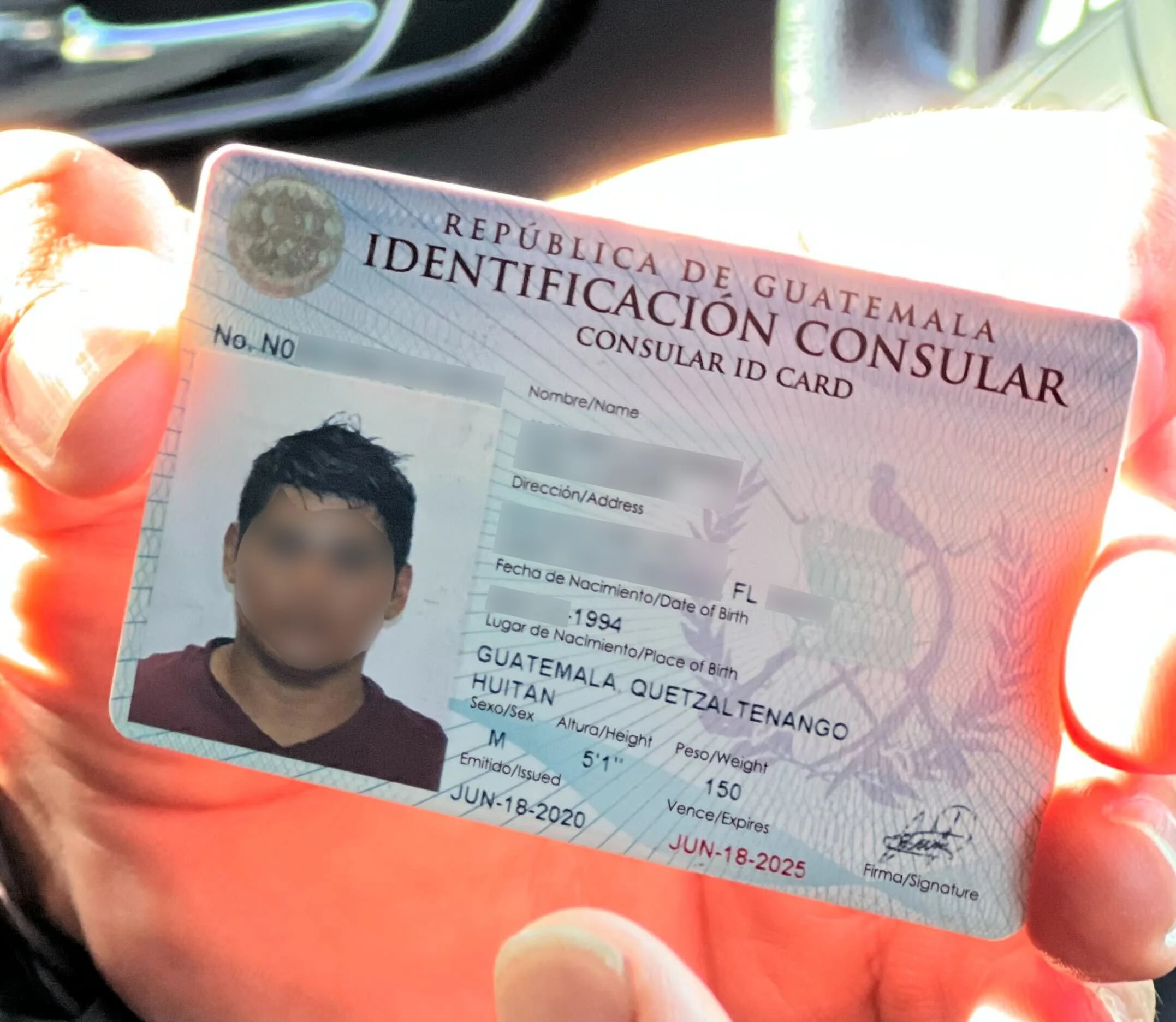 A state trooper holds a Guatemalan consulate ID card that a driver provided during a traffic stop. (Anna Giaritelli / Washington Examiner)