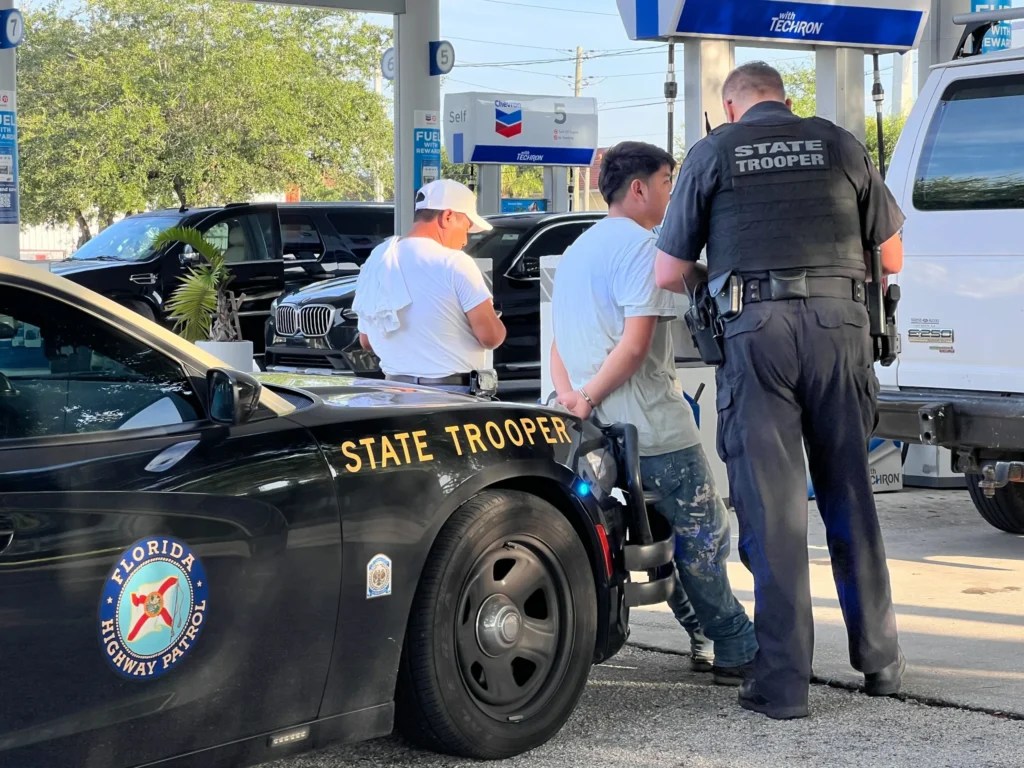 A Florida Highway Patrol state trooper asks two individuals pulled over during a traffic stop about their immigration status. (Anna Giaritelli / Washington Examiner)