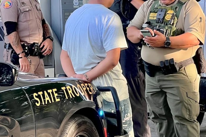 A U.S. Border Patrol agent speaks with an illegal immigrant who was pulled over by Florida Highway Patrol during a traffic stop in July 2024. (Anna Giaritelli / Washington Examiner)