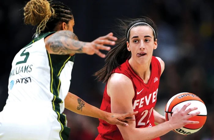Indiana Fever guard Caitlin Clark looks around the defense of Seattle Storm forward Gabby Williams a game on June 24 in Seattle. (Lindsey Wasson/AP)