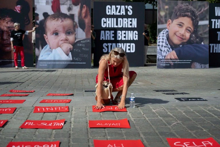 Giant portraits of children from Gaza are displayed in Place Jean Rey during the 