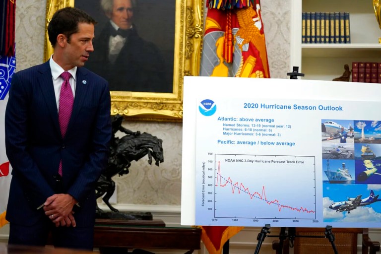 Neil Jacobs, assistant Secretary of Commerce for Environmental Observation and Prediction, listens during a briefing with President Donald Trump on the 2020 hurricane season in the Oval Office of the White House, Thursday, May 28, 2020, in Washington. (AP Photo/Evan Vucci)