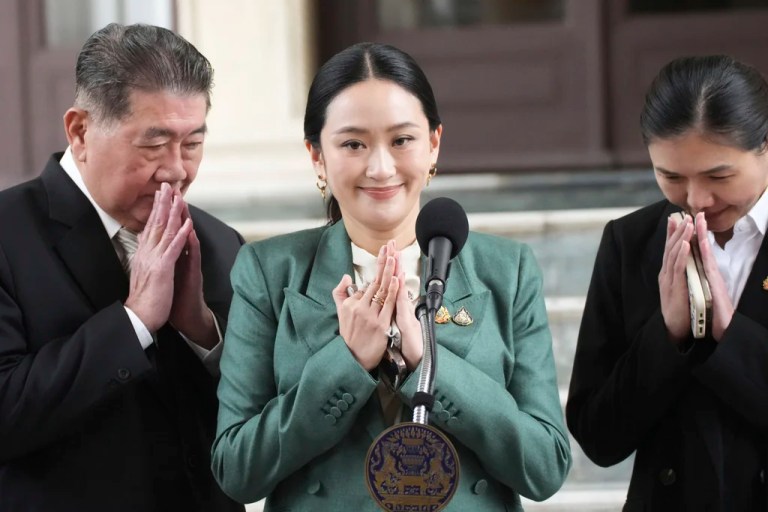 Thailand's Prime Minister Paetongtarn Shinawatra, center, speaks to media at the Government House in Bangkok, Thailand, Tuesday, July 1, 2025, (AP Photo/Sakchai Lalit)