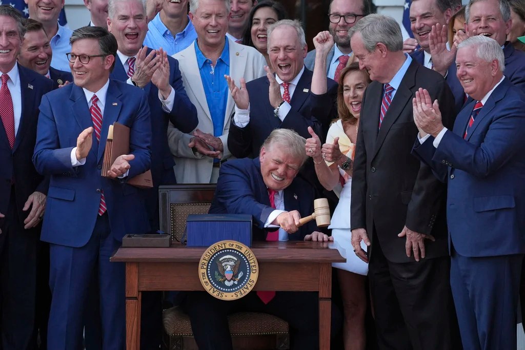 President Donald Trump bangs a gavel presented to him by House Speaker Mike Johnson (R-LA) after he signed his signature bill of tax breaks and spending cuts at the White House, Friday, July 4, 2025, in Washington.