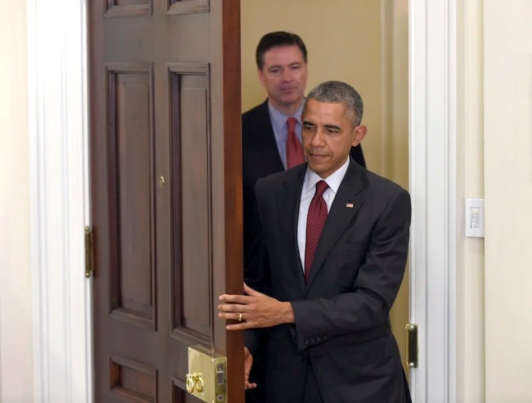 In this Nov. 25, 2015 file photo, former President Barack Obama, followed by former FBI Director James Comey, arrives in the Roosevelt Room of the White House in Washington to brief the public on the nation's homeland security posture heading into the holiday season, following meeting with his national security team. Comey's announcement that his bureau was reviewing new emails possibly relevant to former Secretary of State Hillary Clinton's private email server investigation has thrust him into the public spotlight again just days before Election Day.