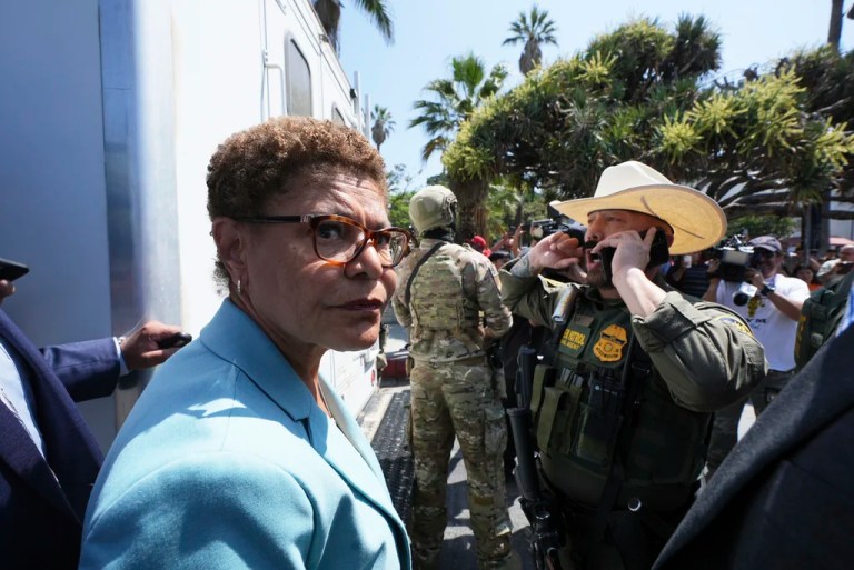 Los Angeles Mayor Karen Bass stands in front of a border patrol federal agent at MacArthur Park Monday, July 7, 2025, in Los Angeles.